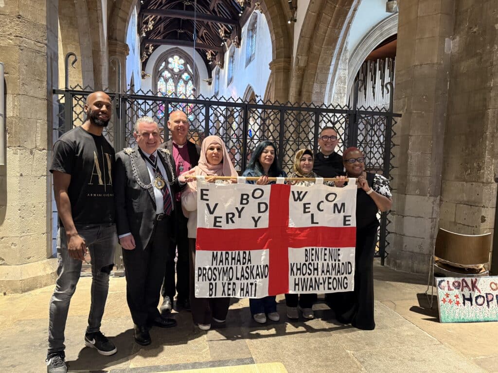 St George’s Day celebration at All Saints Kingston – Stories of Identity & Inclusion. A group photo around the St George Cross